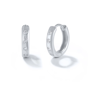 Detail of silver S925 huggie earrings featuring four sparkling round cubic zirconia stones