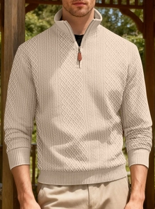 Close-up of beige men's quarter-zip sweatshirt featuring intricate diamond knit texture