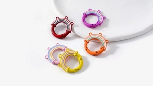 Macro detail of colorful rainbow-shaped metal spring rings on a white ceramic plate