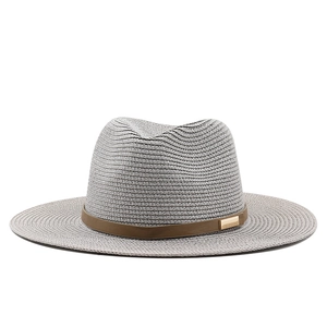 Light gray wide brim straw fedora hat with brown leather band and gold buckle