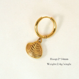 Detailed macro view of a 14K gold seashell pendant earring with 2x14mm hoop size