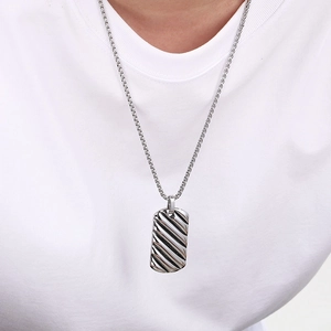 Men's silver stainless steel rectangle pendant necklace with wave texture on white shirt