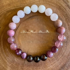 Detail of natural garnet, strawberry quartz and moonstone beaded stretch bracelet