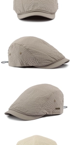 Detail of light khaki flat cap featuring seersucker texture and metal logo plate