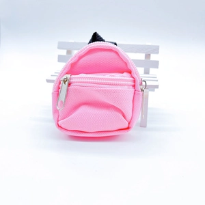Detail shot of bright pink mini backpack coin purse with textured canvas and zippers