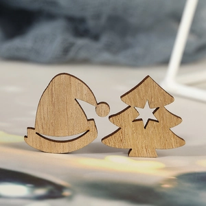 Minimalist laser-cut wooden Christmas tree and hat ornaments with natural grain texture