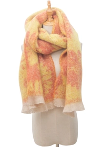Detail of yellow and orange tie-dye scarf featuring soft texture and tassel edges