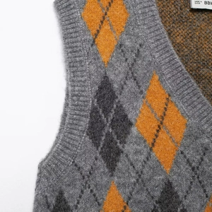 Women's vintage argyle knit vest with grey and orange diamond pattern in soft fabric