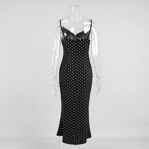 Detailed back view of a black polka dot maxi dress with thin straps on a mannequin