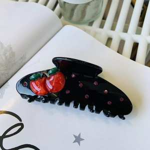 Retro black acetate hair claw clip with red cherry relief and purple rhinestones