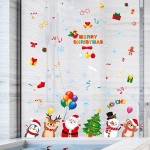 Stickers de Noël électrostatiques avec Père Noël et renne sur une vitre