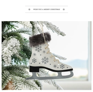 Detail of wooden ice skate Christmas tree ornament with faux fur trim on a snowy branch
