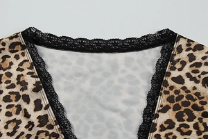 Close-up of leopard print top featuring sexy V-neckline with delicate black lace trim
