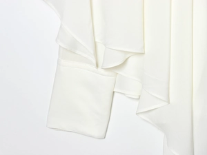 Detail shot of semi-transparent white chiffon fabric with ruffle pleats on the sleeve