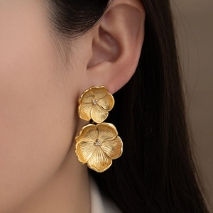 Matte gold twin flower earrings with crystal center and vintage textured petals