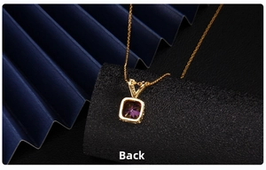 Macro detail of the golden heart pendant back showing hollow metal craft and purple zircon