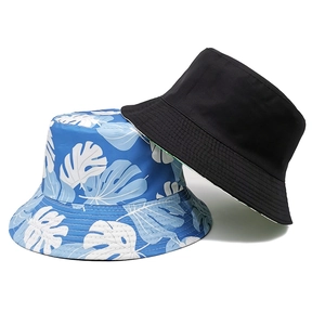 Reversible tropical leaf print and solid black bucket hat for sun protection