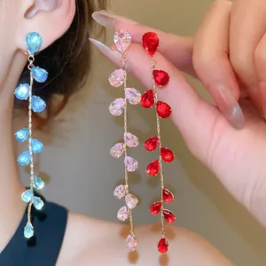 Sparkling teardrop crystal tassel earrings in blue, pink, and red with gold-plated finish