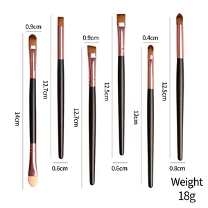 Set of 6 eye makeup brushes with matte black handles and rose gold ferrules on white
