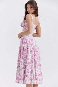 Detail view of pink floral summer dress showing slim waist cut and strap design