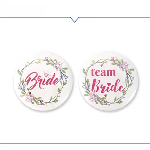 Detail of floral Bride and Team Bride tinplate badges for bridal shower decorations