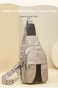Detail of khaki crossbody bag with brown leather accents and geometric strap