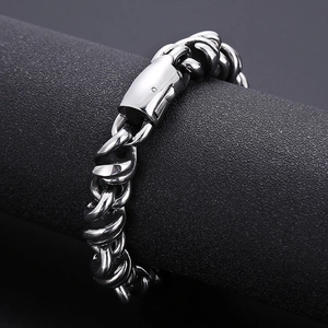 Detailed view of heavy silver titanium steel chain bracelet on a black display stand