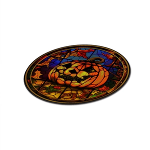 Macro shot of circular Halloween pumpkin stained glass acrylic pendant with iron chain
