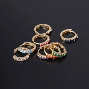 Golden earrings with colorful zirconia stones in pink blue and green on black background