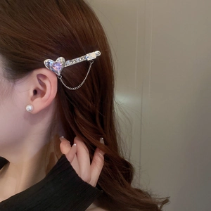 Y2K metal hair clip with purple heart gemstone and chain tassel on brown hair