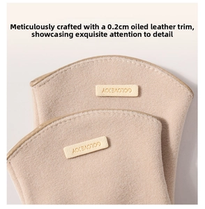 Detail of beige fleece fabric featuring fine 0.2cm faux leather piping and logo patch