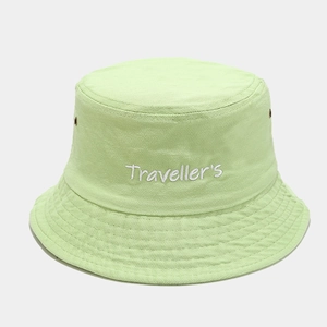 Detail of Traveller's embroidery and metal eyelets on light green cotton bucket hat