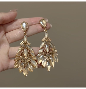Macro detail of champagne crystal teardrop earrings with luxury rhinestone marquise cuts