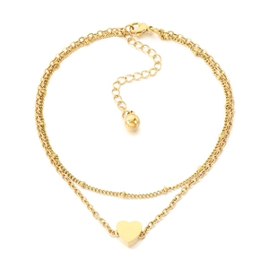 Double-layered gold anklet with heart pendant and bead chain on white background