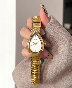 Close-up of GEDI teardrop luxury watch with zircon bezel on female wrist with sweater