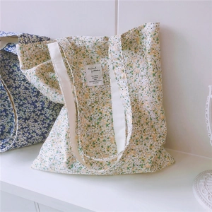 Close-up of floral cotton tote bag with detailed embroidery and fabric texture