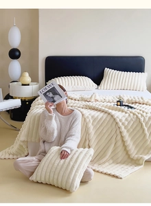 Detailed close-up of thick beige flannel bedding with raised tactile stripe textures
