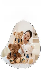 Three plush teddy bears with stylish ties and straps held by a model in a cozy home