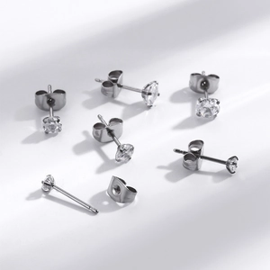 Detail showing 4-prong set clear round cubic zirconia earrings with butterfly backs