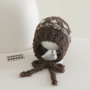 Close-up of the soft plush knit texture and chin straps on the warm winter earflap hat