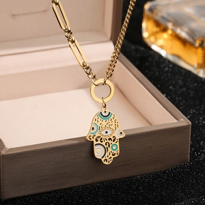 Gold Hamsa Hand necklace with blue enamel on a mixed paperclip and twist chain