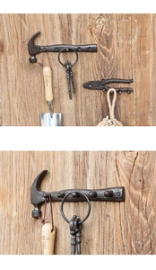 Macro detail of industrial cast iron hammer and pliers wall hooks on rustic wood
