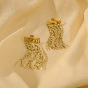 Exaggerated tassel earrings with 18k gold plated stainless steel chains on silk background