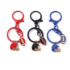 Set of three American football helmet and ball keychains in red, black, and blue metal finish