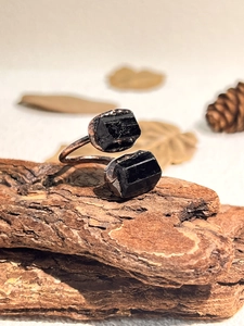Macro detail of natural black tourmaline stone on a vintage style adjustable copper ring