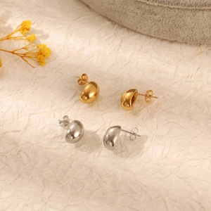 Minimalist bean-shaped stud earrings in gold and silver finish with high-gloss mirror surface