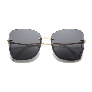 Frameless oversized butterfly sunglasses with gradient grey lenses and gold metal temples