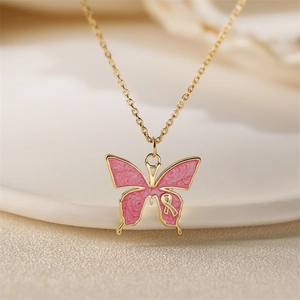 Elegant gold necklace with pink marble enamel butterfly pendant on white ceramic plate