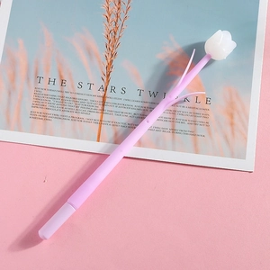 Macro detail of a purple tulip-shaped silicone pen on a pink aesthetic card background