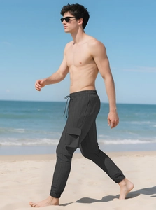 Close-up of grey cargo joggers featuring drawstring waist and large side utility pocket